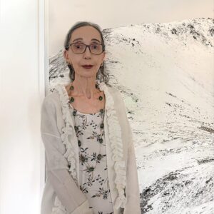 Headshot of Joyce Carol Oates in front of artwork.