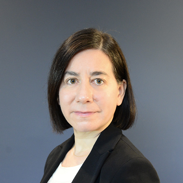 Mailan Doquang author photo; woman with short, dark hair wearing black blazer and white shirt