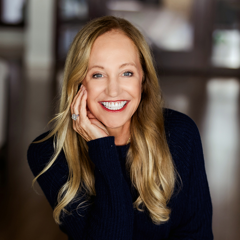 Kaira Rouda author photo. Headshot of a woman with long blonde hair, resting her head on her hand