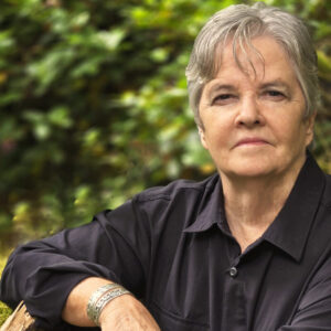 Headshot of author Deborah J Ledford outside in front of trees.